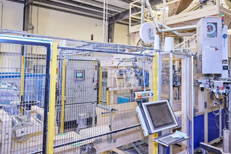 Automated bagging and labeling equipment for powdered milk replacers at Esmilco’s repackaging facility in Central California
